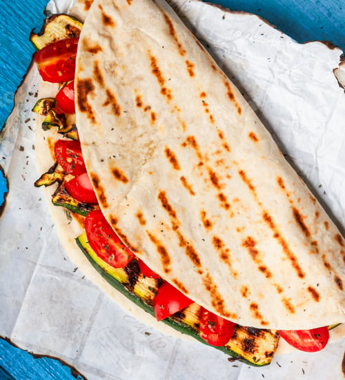 Grilled Vegetables in Flatbread on Rustic Wooden Table