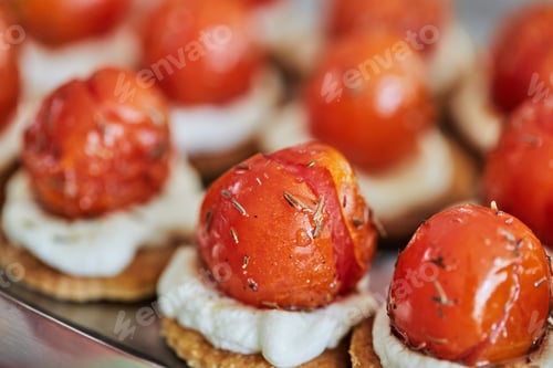 Preview: Appetizers with ricotta cheese and cherry tomatoes on serving tray