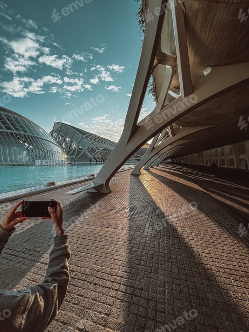 Preview: a woman takes a picture of modern architecture