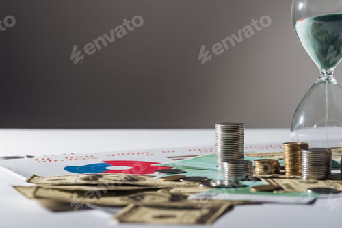 Preview: selective focus of coins stacks, hourglass on dollar and euro banknotes