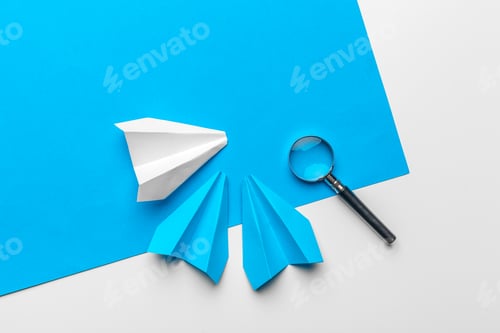 Preview: paper plane with office supplies on blue background