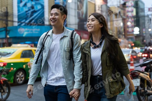 Preview: Asian active young couple travel in city for honeymoon trip at night.