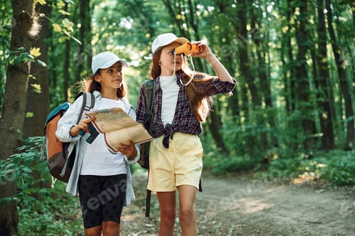 Preview: Using the map. Two girls is in the forest having a leisure activity, discovering new places