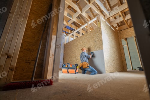 Preview: Construction Worker Installs Drywall in a Newly Framed Room