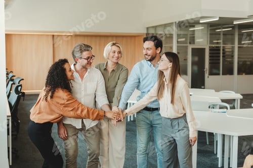 Preview: Smiling business colleague holding hands together in a huddle in office. Meeting, teamwork concept