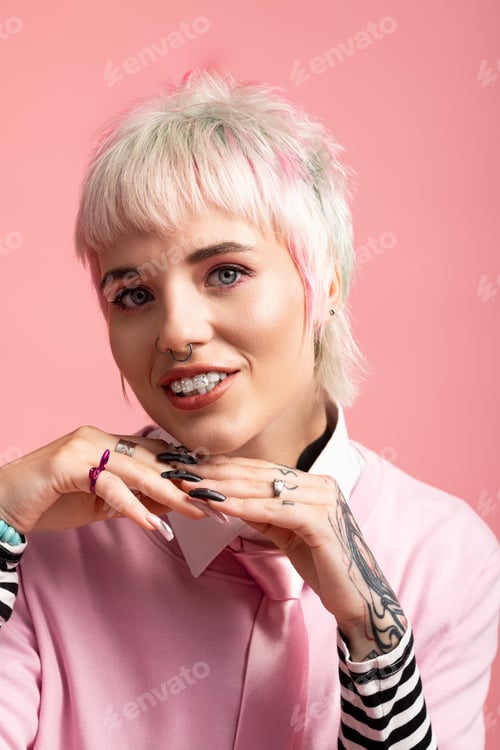 Preview: Portrait of a young woman with vibrant style and playful charm set against a soft pink backdrop
