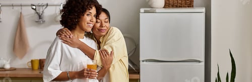 Preview: Affectionate Women Embracing in an Airy Kitchen