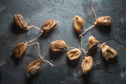 Preview: Dried figs with a string on a gray stone