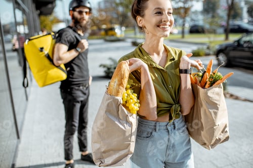 Preview: Woman with fresh products received from a courier