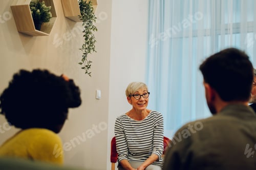 Preview: Senior woman talking about her mental health on a group therapy session