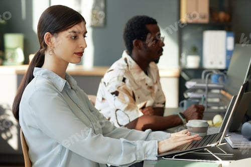 Preview: People at Work Desk in Office
