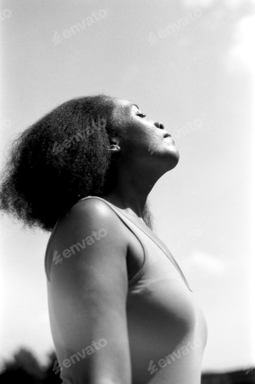 Preview: Woman breathing fresh air on sunny day, analog black and white film portrait