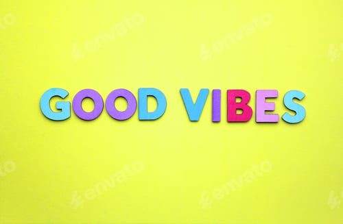Preview: Good vibes spelled out in multicolored wooden letters on a bright yellow background