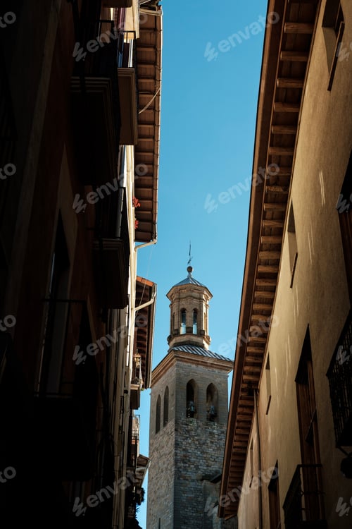 Preview: Church tower emerging from narrow street in Pamplona, spain