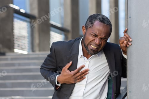 Preview: Heart attack , african american businessman has severe chest pain , man holding his hands over
