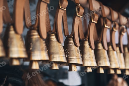 Preview: Brass bells hanging outside on leather straps