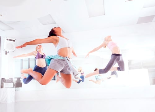 Preview: Young female ballet dancers practicing in dance studio, jumping in unison