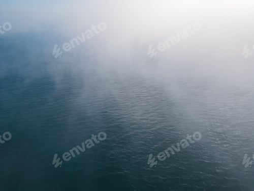 Preview: drone flight over the sea in the fog in the morning