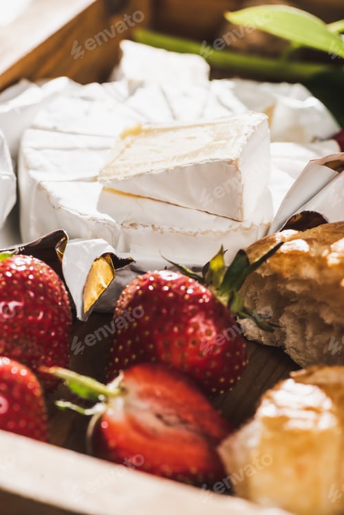 Preview: Close up View of French Breakfast With Croissant, Camembert, Strawberries on Wooden Tray