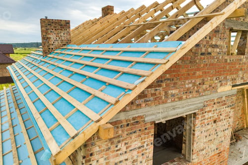 Preview: Aerial view of a brick house with wooden roof frame under construction