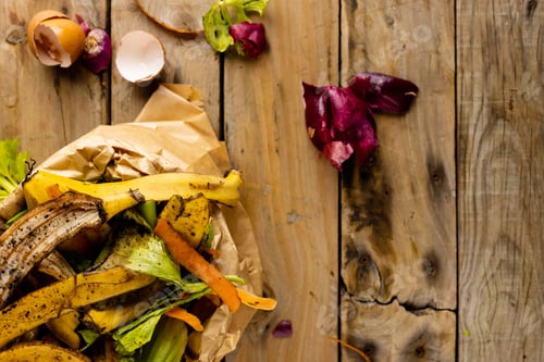 Preview: Overhead of organic fruit and vegetable food waste spilling from full kitchen composting bin