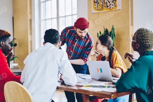 Preview: Diverse people discussing business strategy during brainstorming meeting in coworking