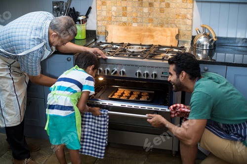 Preview: Family keeping cookies in oven