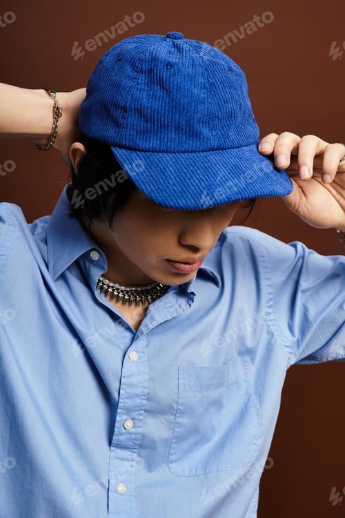 Preview: Fashion forward young man showcases unique style in studio setting