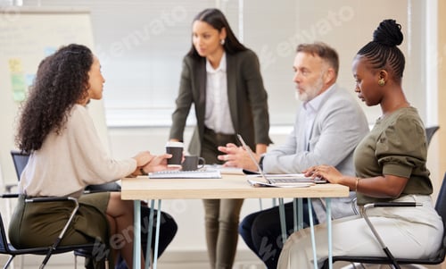 Preview: Distractions wont make her lose focus. Shot of a group of businesspeople in a meeting at work.