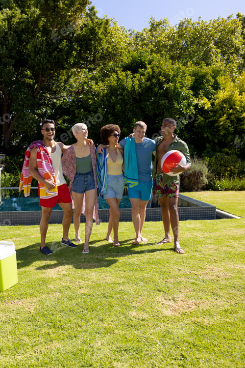 Preview: Happy diverse group of friends having pool party, embracing and smiling in garden