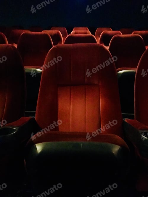 Preview: Rows of red seats at movie theatre.