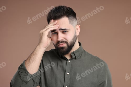 Preview: Portrait of sad man on brown background