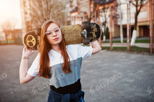 Preview: Young teenage urban girl with skateboard