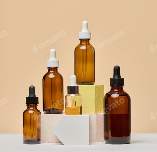 Preview: Various glass bottles with pipettes containing cosmetic serums or oils.