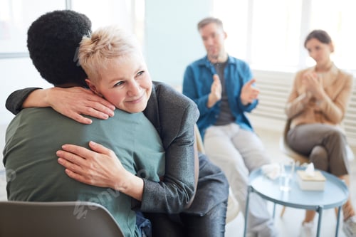 Preview: Mature Psychologist Embracing Patient in Support Group