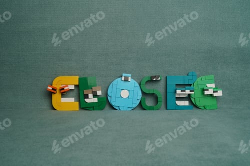 Preview: Miniature figure of the word Closed against a greenish fabric background