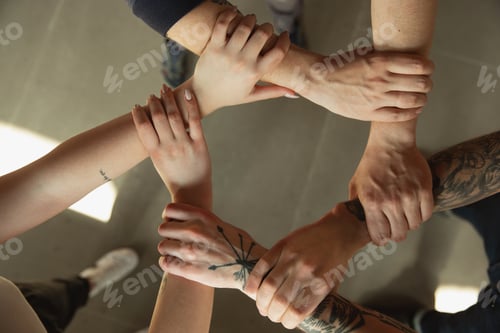 Preview: Close up of caucasian male and female hands, covering one another, team, friendship, business