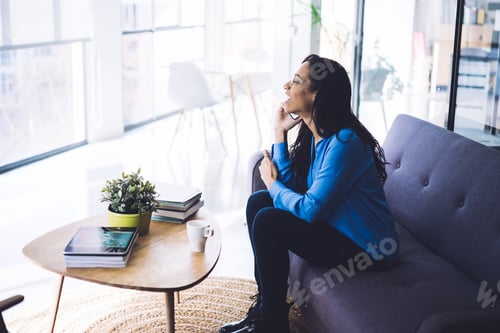 Preview: Laughing young modern woman having phone call at home