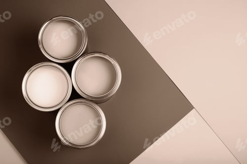 Vista previa: Four paint cans on a brown and beige background in soft lighting