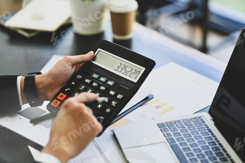 Preview: Closeup male accountant calculating budget and loan paper at office desk