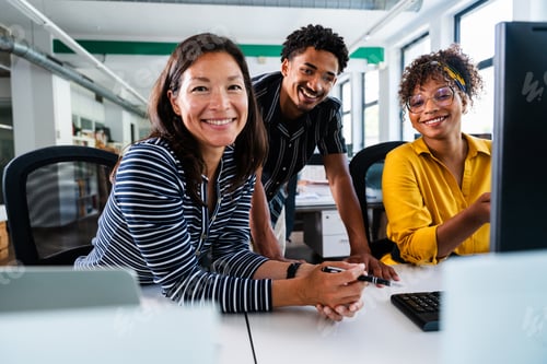 Preview: Business people collaborating on computer in startup office