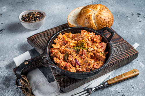 Preview: Turkish breakfast with Menemen omelet and bread. Dark background. Top view