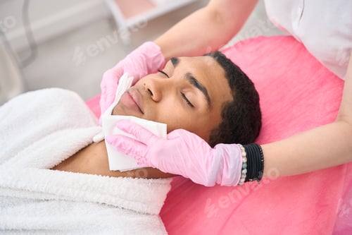 Preview: Beauty salon aesthetician preparing client for cosmetic procedure