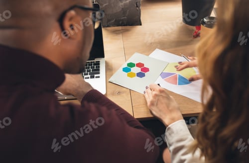 Preview: Colleagues working together in modern office using devices and gadgets during negotiations