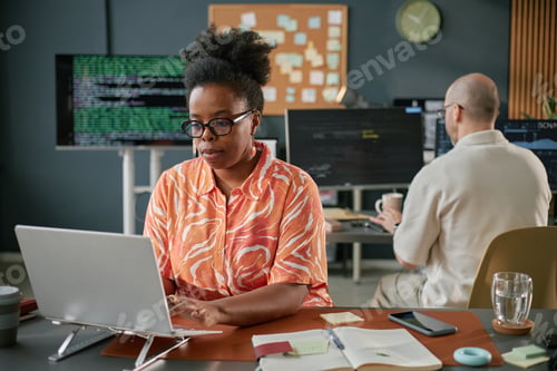 Preview: Middle Aged Black Woman Working on Laptop in Modern Office Environment