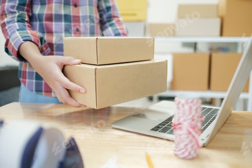 Preview: Online business owner preparing product to customer.