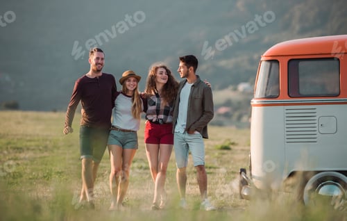 Preview: A group of young friends on a roadtrip through countryside, walking.