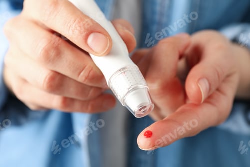 Preview: Woman checking blood sugar level, close up
