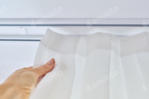 Preview: Translucent white textured curtain on window, close-up of cornice and fabric gathered on braid
