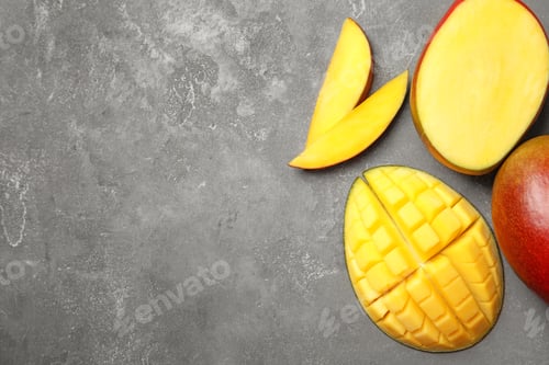 Preview: Flat lay composition with ripe mangoes and space for text on grey background